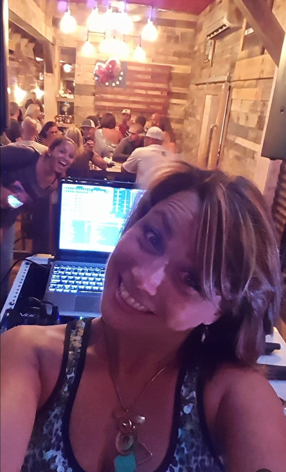 DJ Sunshyne performing in a lively venue